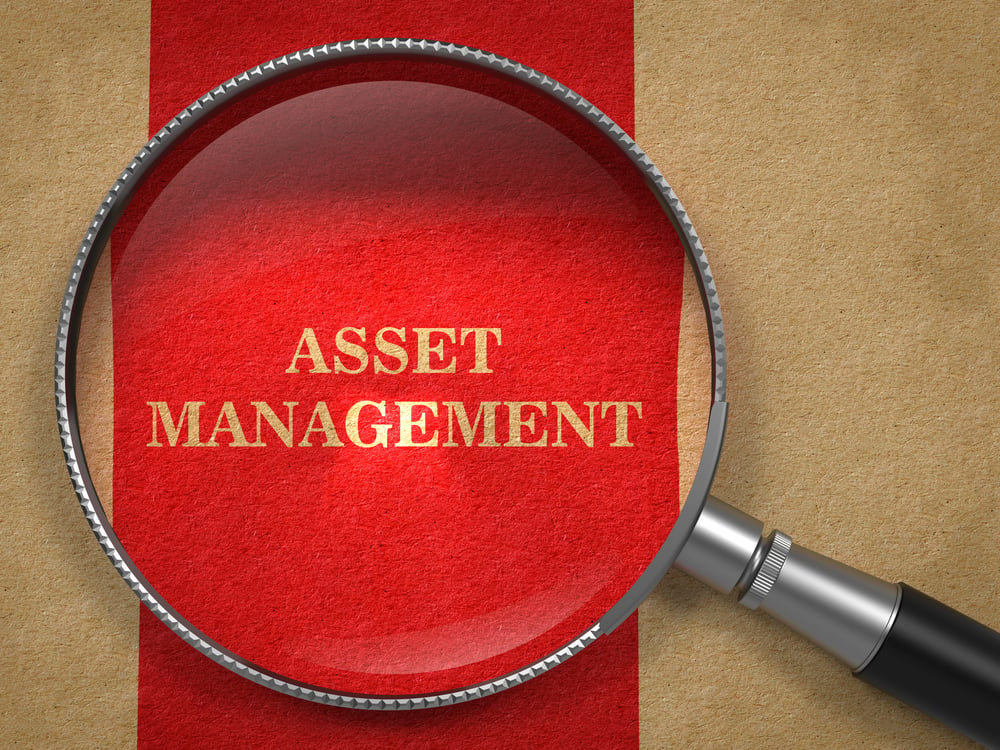 Asset Management. Magnifying Glass on Old Paper with Red Vertical Line.